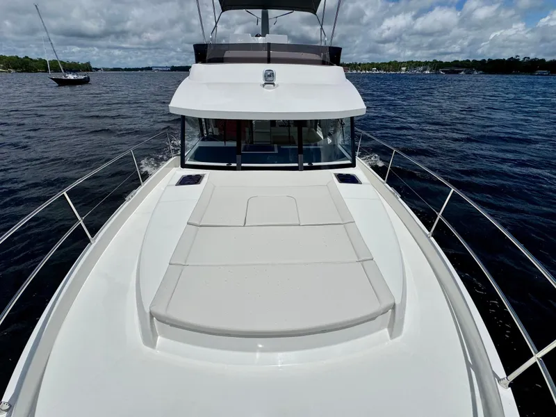 Slide: The Image of 2025 Beneteau Swift Trawler 41 Fly on water, showcasing spacious deck and sleek design. - 27