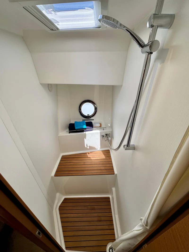 Slide: The Image of 2025 Beneteau Swift Trawler 41 Fly shower with wooden flooring and modern fixtures. - 6
