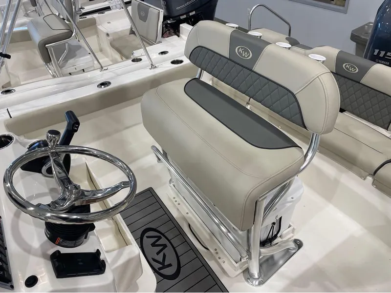 Slide: The Image of 2025 Key West 189 FS boat interior with steering wheel and cushioned seating. - 8