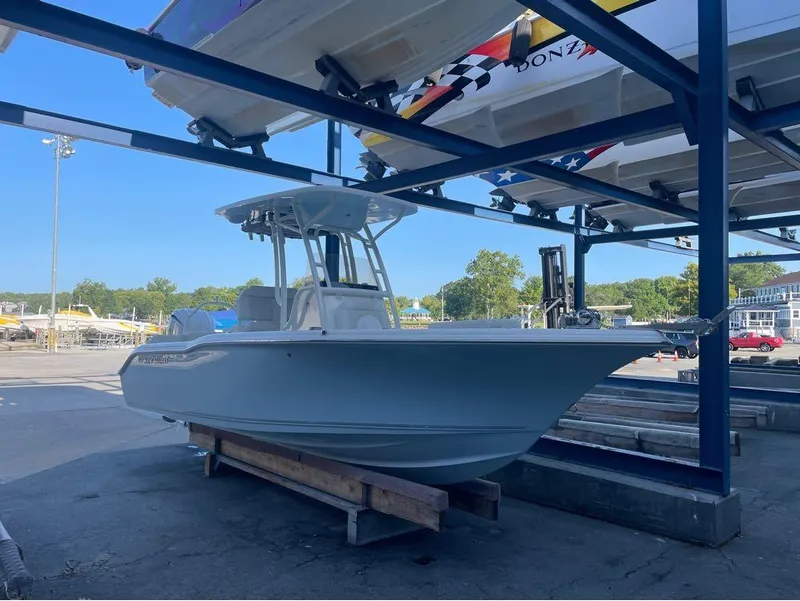 Slide: The Image of 2025 Key West 239 FS boat in storage, marina background, sunny day. - 17