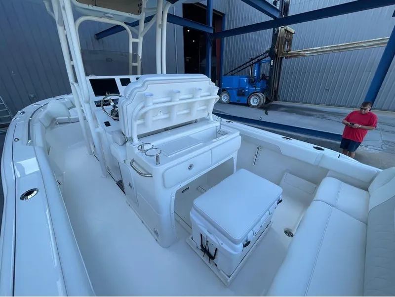 Slide: The Image of 2025 Key West 239 FS boat interior with seating and console, dockside view. - 18