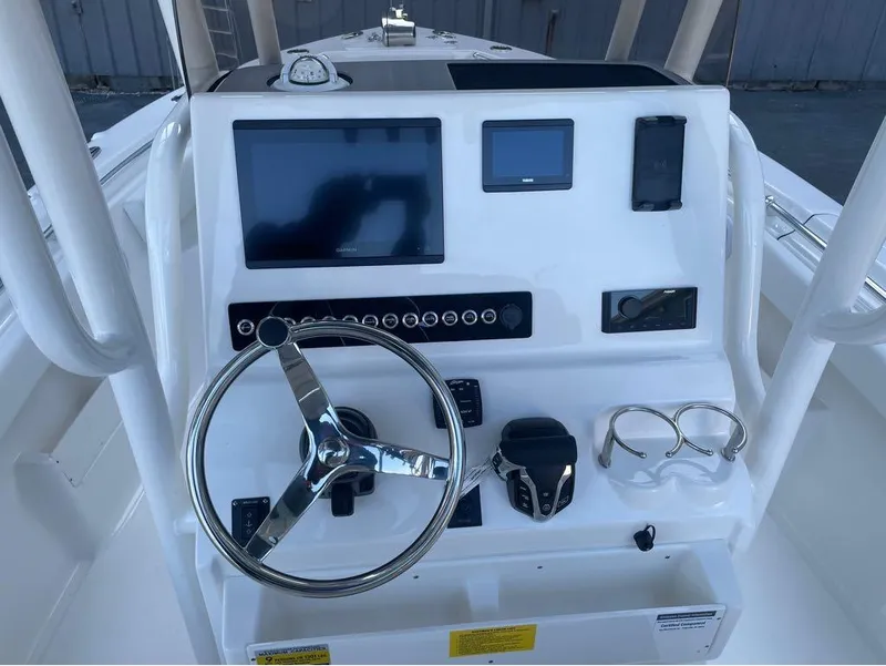 Slide: The Image of 2025 Key West 239 FS boat dashboard with steering wheel and electronic displays. - 3