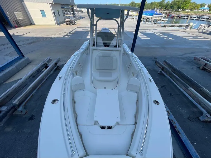 Slide: The Image of 2025 Key West 239 FS boat docked at marina, showcasing spacious seating and sleek design. - 6