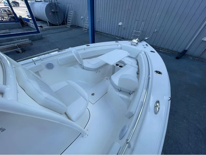 Slide: The Image of 2025 Key West 239 FS boat interior with white seating and table. - 8