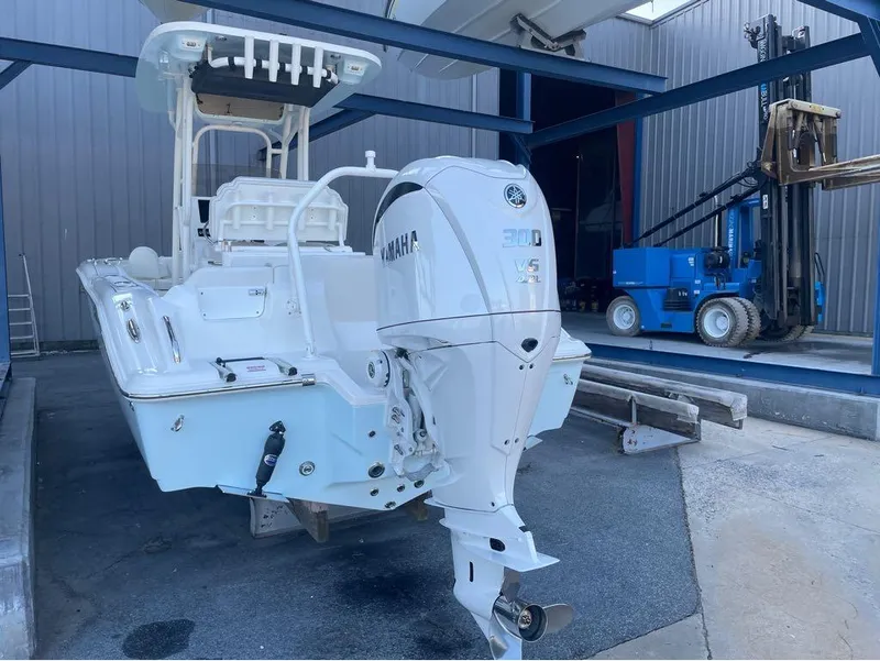 Slide: The Image of 2025 Key West 239 FS boat with Yamaha 300 V6 engine in storage facility. - 9
