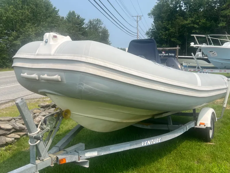 Slide: The Image of 2005 Apex Marine 17 inflatable boat on trailer, parked on grass. - 13