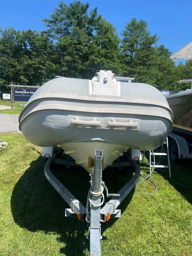 Slide: The Image of 2005 Apex Marine 17 inflatable boat on trailer, parked on grass. - 3