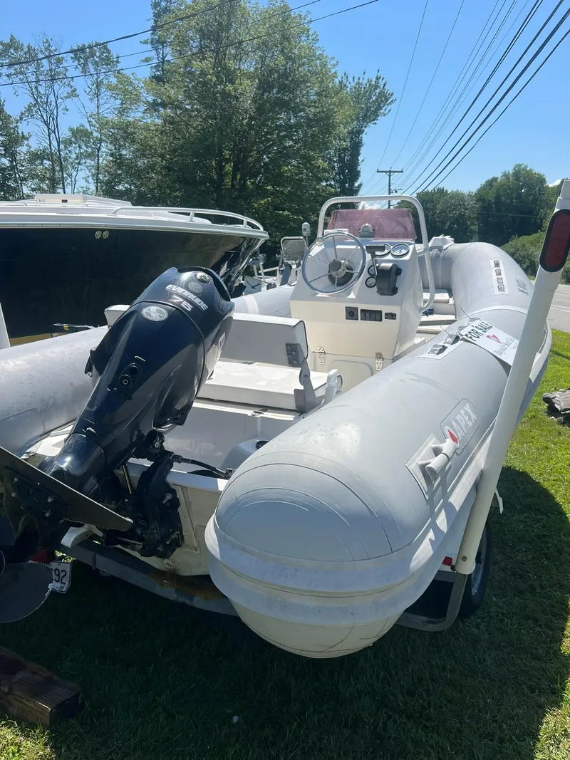 Slide: The Image of 2005 Apex Marine 17 inflatable boat with outboard motor on grassy area. - 4