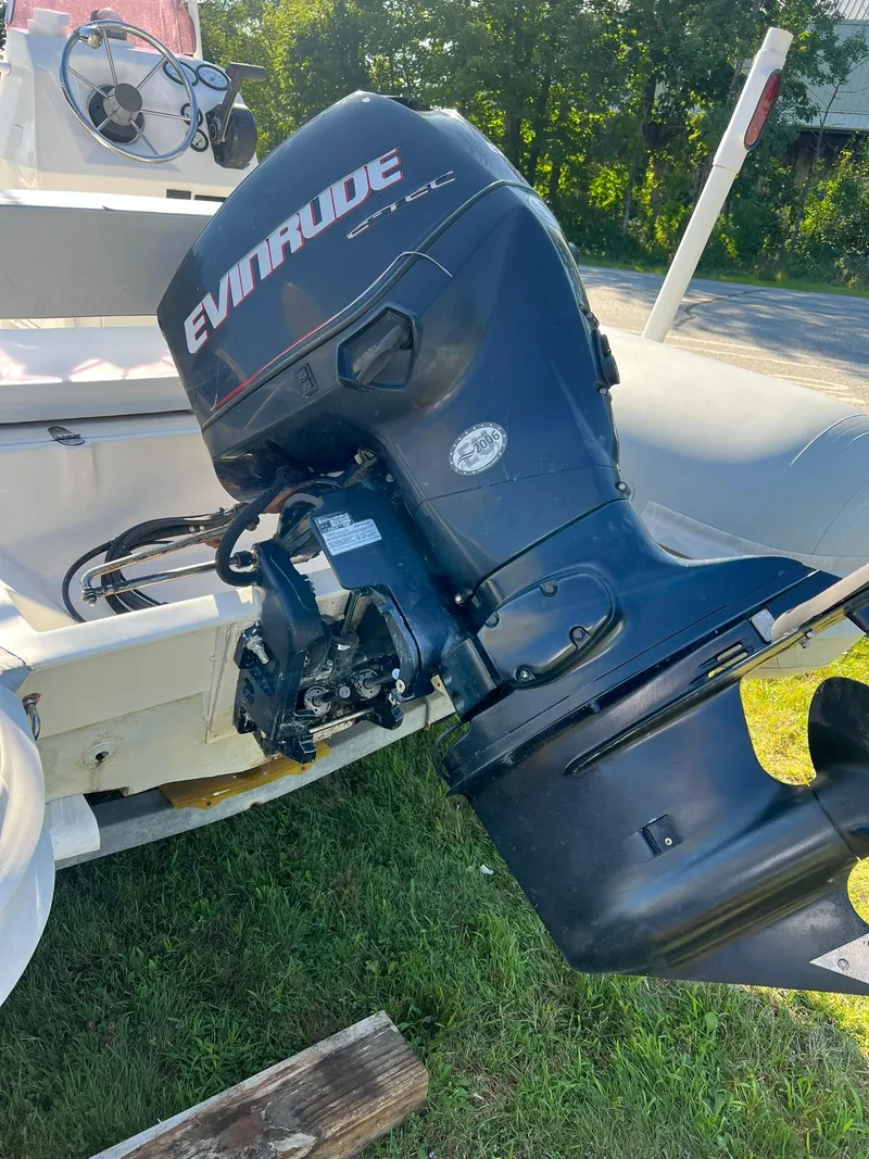Slide: The Image of 2005 Apex Marine 17 boat with Evinrude outboard motor on grass. - 5