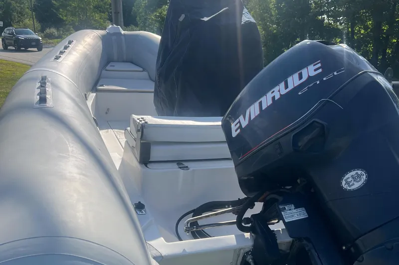 Slide: The Image of 2005 Apex Marine 17 boat with Evinrude motor, docked outdoors. - 9