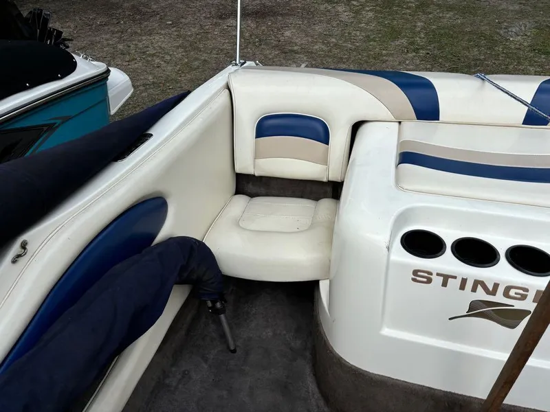 Slide: The Image of Interior of a 1999 Stingray 190RS boat with white and blue seating. - 11