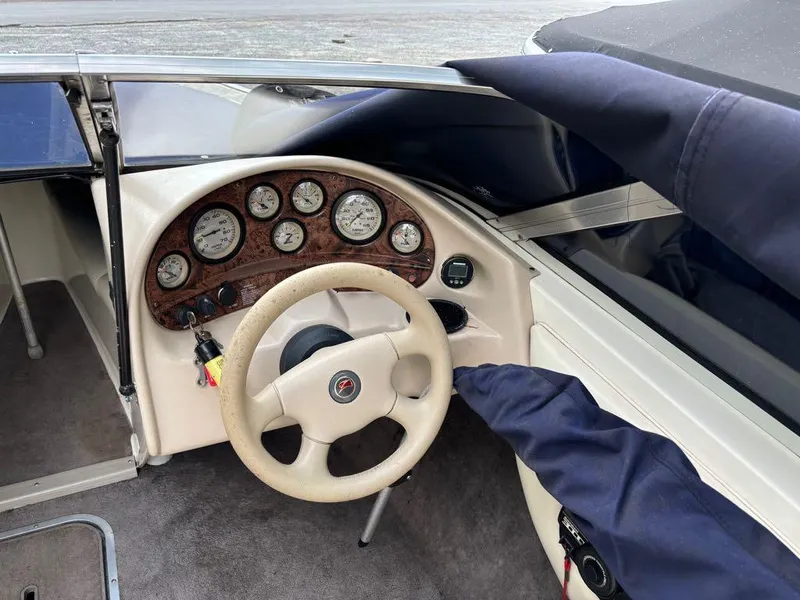 Slide: The Image of 1999 Stingray 190RS boat dashboard with steering wheel and instrument panel. - 12
