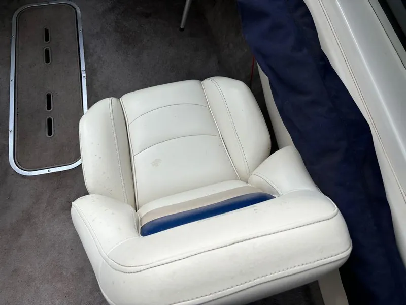 Slide: The Image of White leather seat in a 1999 Stingray 190RS boat interior. - 28