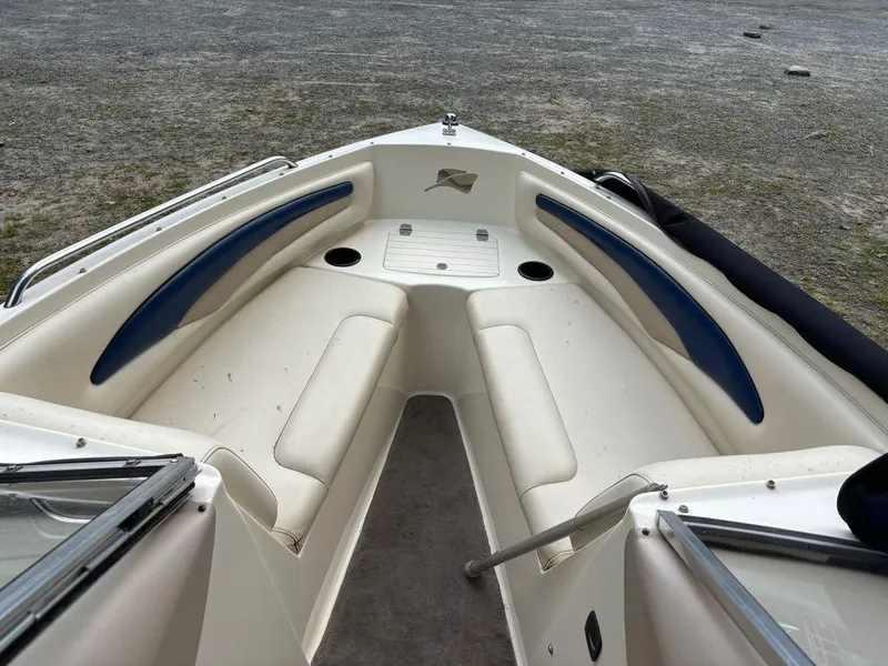 Slide: The Image of 1999 Stingray 190RS boat interior with white and blue seating, viewed from the bow. - 4