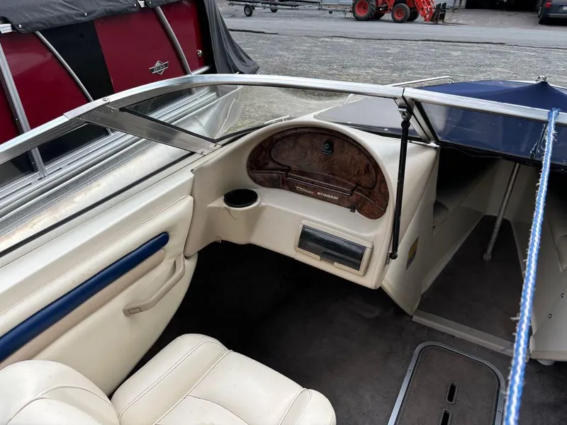Slide: The Image of Interior of a 1999 Stingray 190RS boat with beige seating and dashboard. - 5
