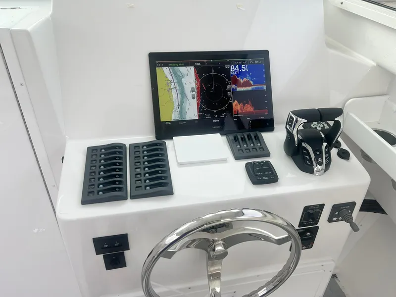 Slide: The Image of 2024 Steiger Craft 31 Fisherman helm with navigation display and controls. - 11