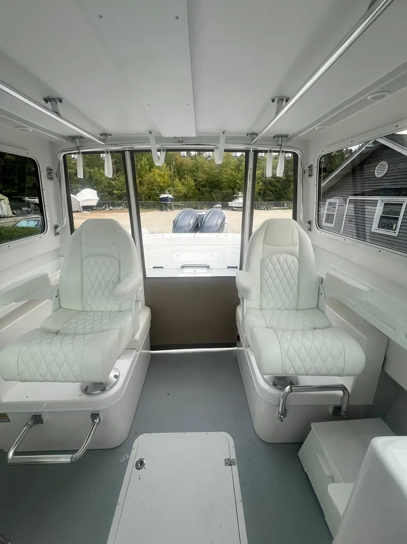 Slide: The Image of 2024 Steiger Craft 31 Fisherman interior with white seating and spacious cabin design. - 12