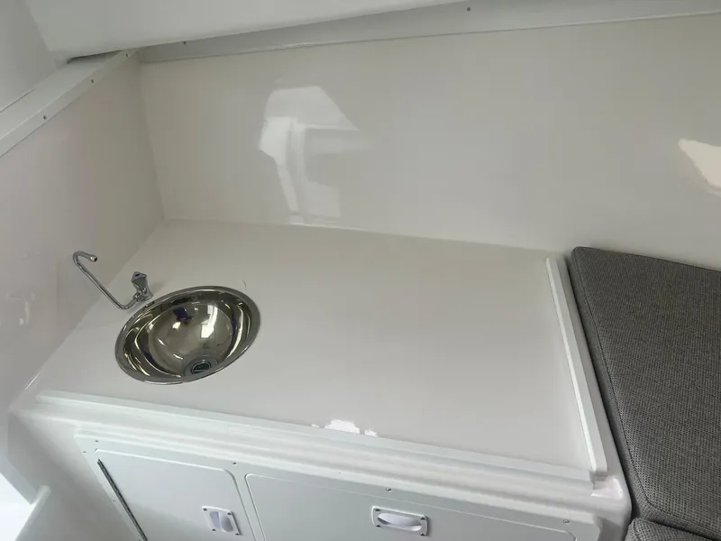 Slide: The Image of 2024 Steiger Craft 31 Fisherman interior with sink and cushioned seating. - 20