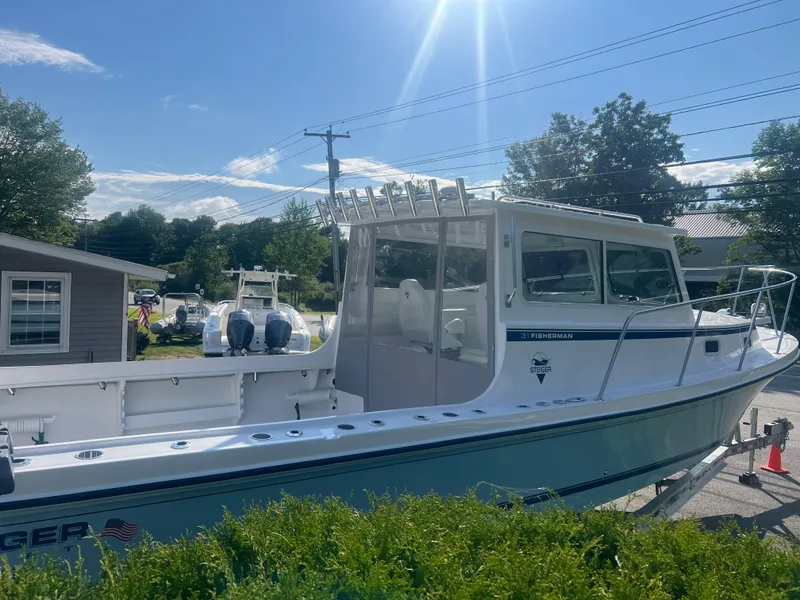 Slide: The Image of 2024 Steiger Craft 31 Fisherman boat under sunny sky, parked outdoors. - 5