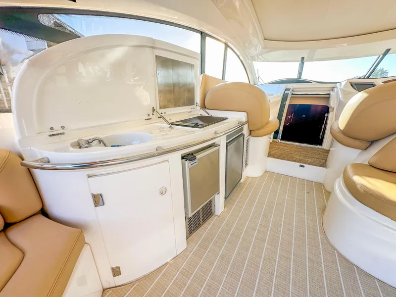 Slide: The Image of Luxurious interior of 2002 Sunseeker Predator 61 yacht with kitchenette and seating area. - 13