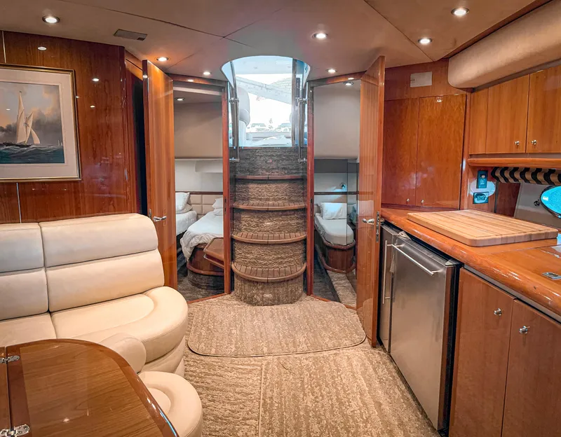 Slide: The Image of Luxurious interior of 2002 Sunseeker Predator 61 yacht with elegant wood finishes and modern amenities. - 17