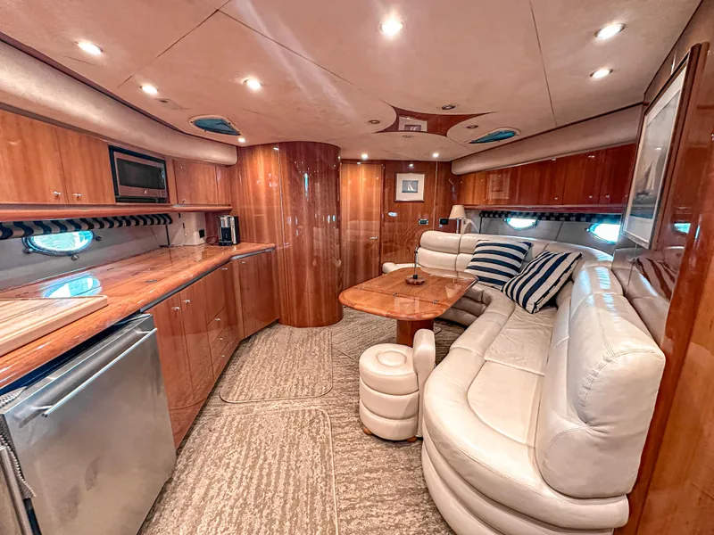 Slide: The Image of Luxurious interior of 2002 Sunseeker Predator 61 yacht with elegant wood finishes and plush seating. - 19