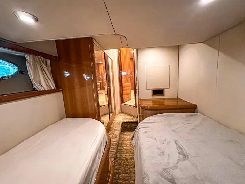 Slide: The Image of Luxurious cabin interior of 2002 Sunseeker Predator 61 yacht with twin beds. - 23