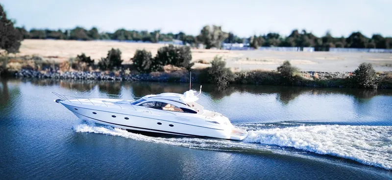 Slide: The Image of Sunseeker Predator 61 yacht cruising on a calm river, 2002 model. - 3