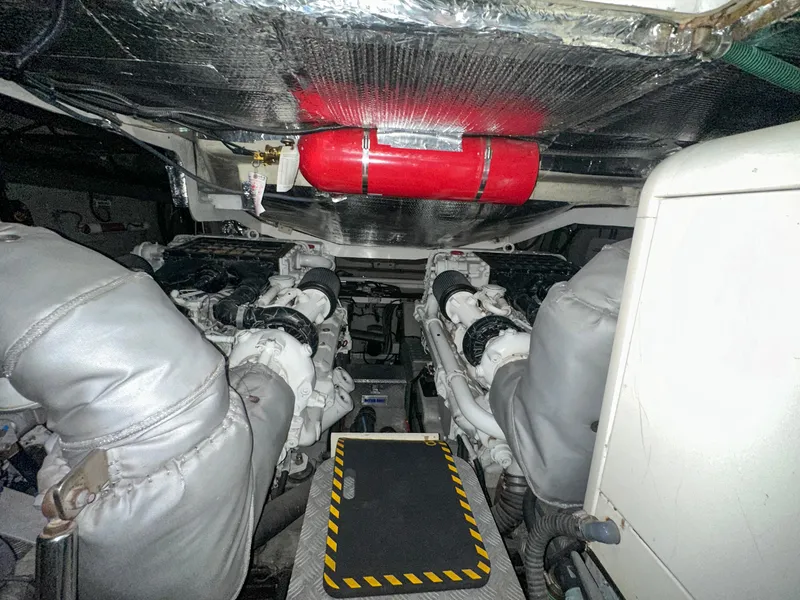 Slide: The Image of Engine room of 2002 Sunseeker Predator 61 yacht, featuring dual engines and fire extinguisher. - 30