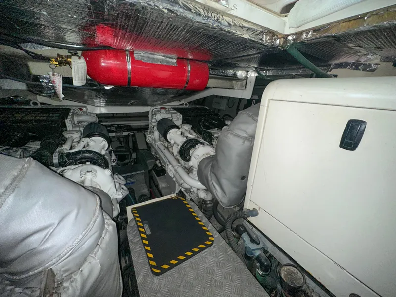 Slide: The Image of Engine room of 2002 Sunseeker Predator 61 yacht, featuring dual engines and safety equipment. - 32