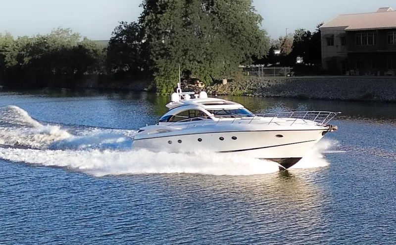 Slide: The Image of Sunseeker Predator 61 yacht cruising on a serene river, 2002 model. - 4
