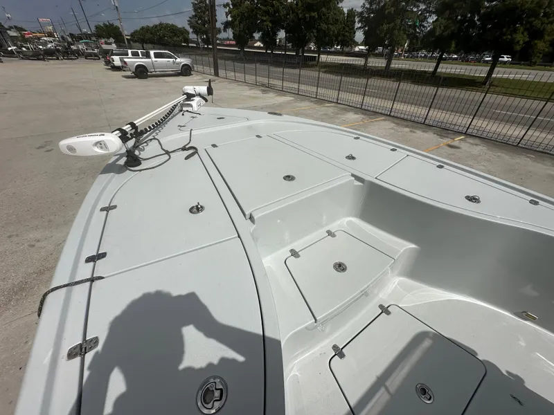 Slide: The Image of 2021 Blazer 2700 HYBRID BAY boat deck with storage compartments and trolling motor. - 16