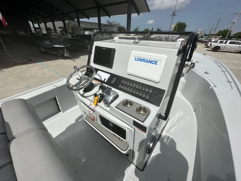 Slide: The Image of 2021 Blazer 2700 HYBRID BAY boat console with Lowrance electronics in a marina setting. - 18