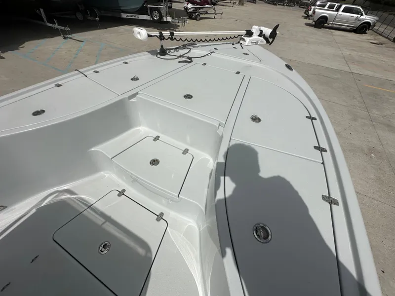 Slide: The Image of 2021 Blazer 2700 HYBRID BAY boat deck with storage compartments and trolling motor. - 19