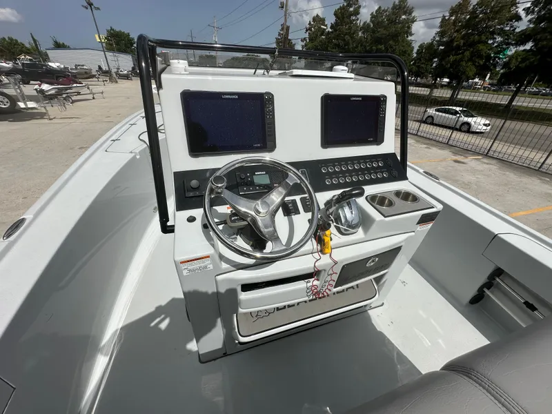 Slide: The Image of 2021 Blazer 2700 HYBRID BAY boat console with dual screens and steering wheel. - 20