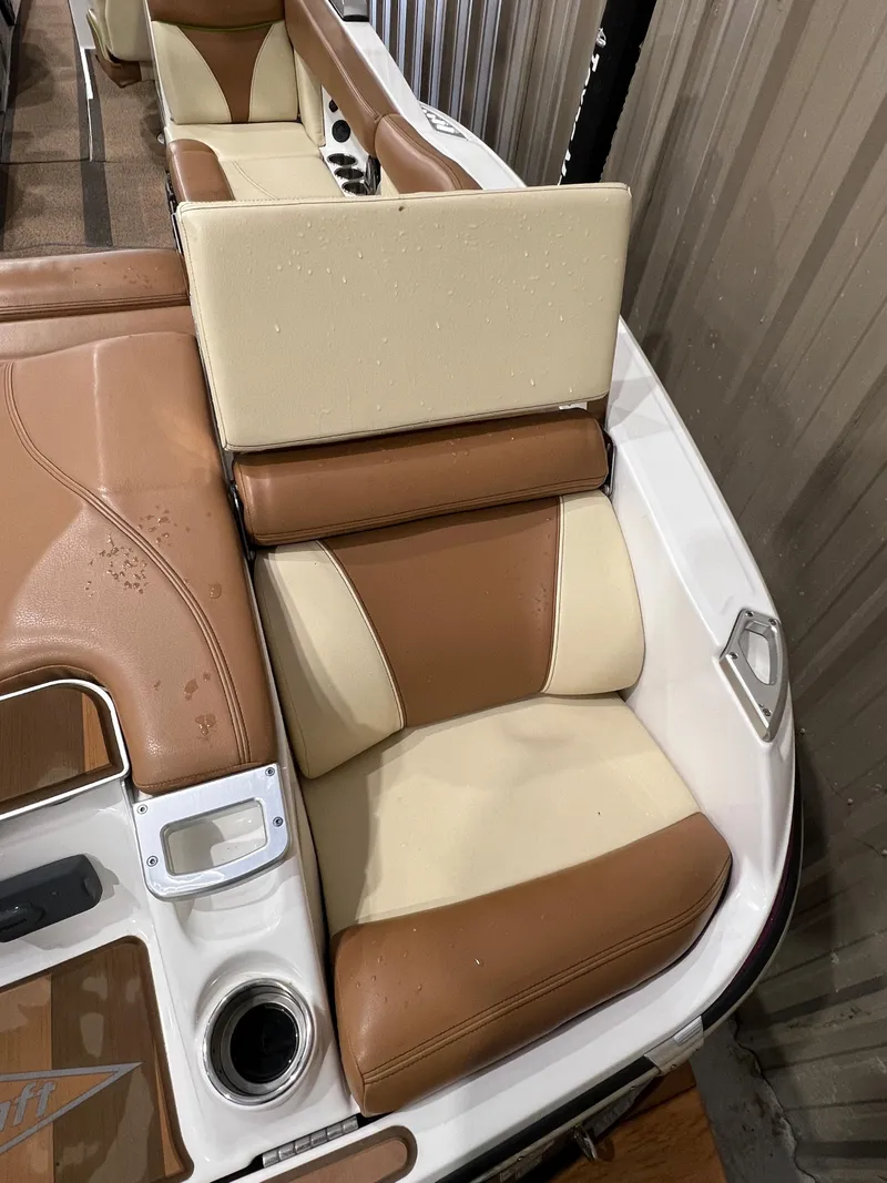 Slide: The Image of 2016 MasterCraft X26 boat interior with tan and cream leather seats. - 14