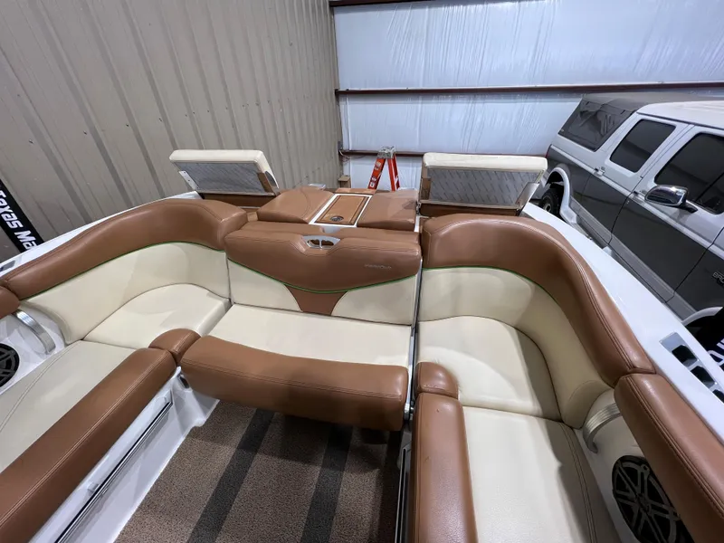 Slide: The Image of 2016 MasterCraft X26 boat interior with brown and cream seating. - 17