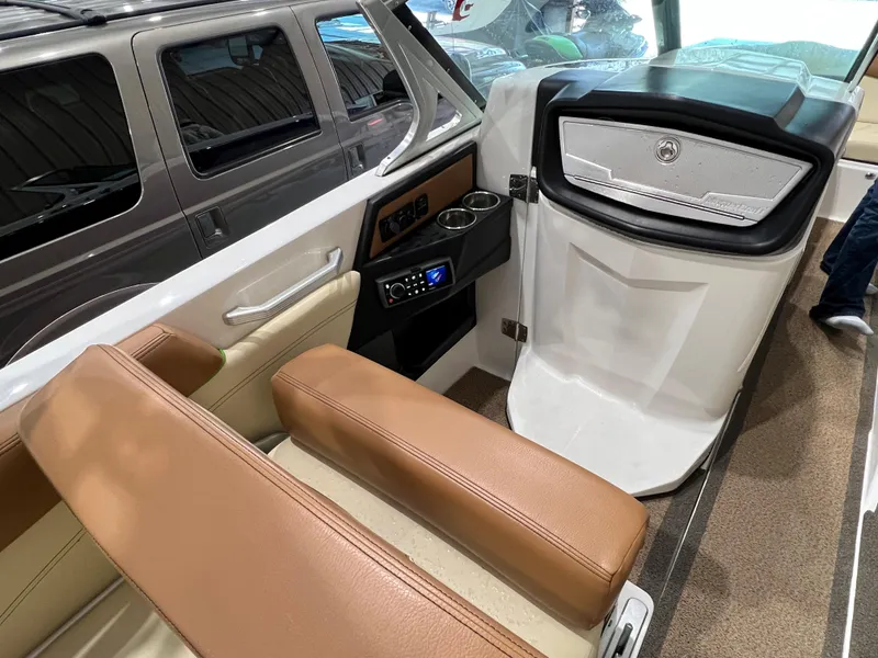 Slide: The Image of 2016 MasterCraft X26 boat interior with tan seating and modern dashboard. - 34