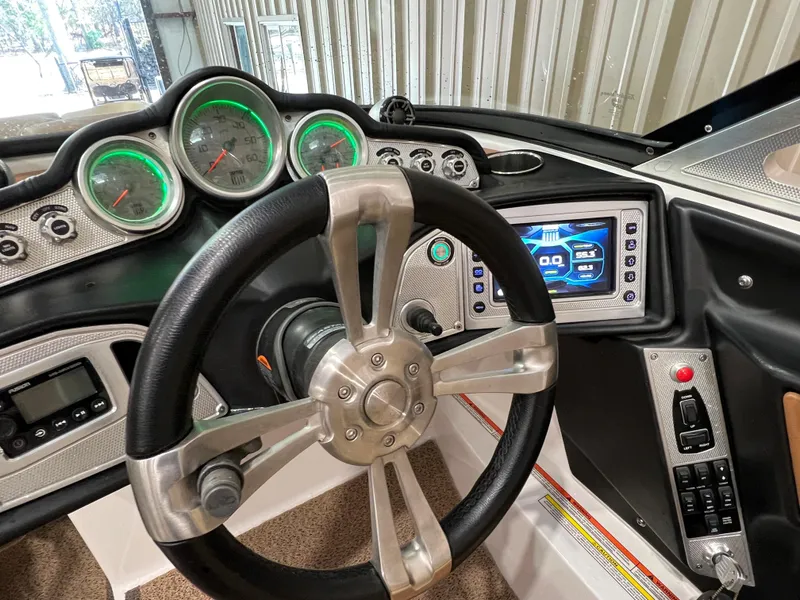 Slide: The Image of 2016 MasterCraft X26 dashboard with steering wheel and digital display. - 39