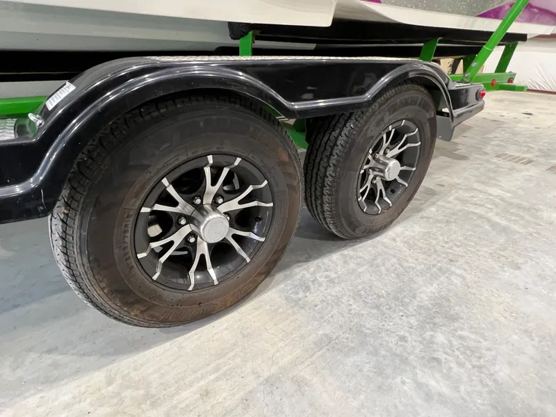 Slide: The Image of 2016 MasterCraft X26 trailer wheels on concrete floor. - 9