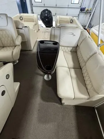 Slide: The Image of 2013 Bennington 2575 R pontoon boat with beige seating and central console. - 14