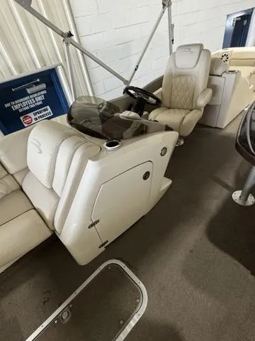 Slide: The Image of 2013 Bennington 2575 R boat interior with beige seating and steering console. - 15