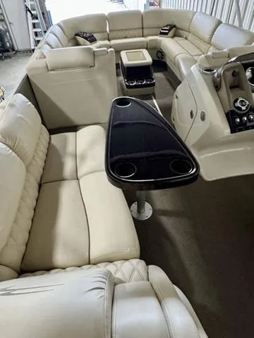Slide: The Image of 2013 Bennington 2575 R pontoon boat interior with beige seating and sleek control panel. - 16