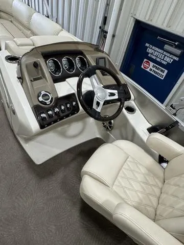 Slide: The Image of 2013 Bennington 2575 R boat interior with steering wheel and control panel. - 18