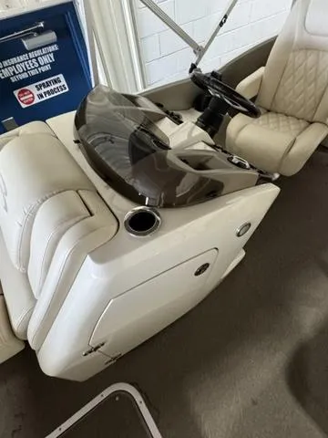 Slide: The Image of 2013 Bennington 2575 R boat interior with steering console and cushioned seating. - 21