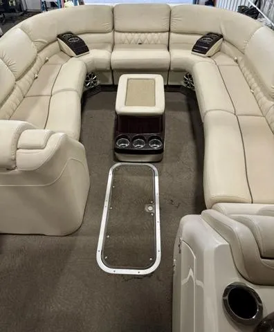 Slide: The Image of 2013 Bennington 2575 R pontoon boat interior with beige seating and central console. - 23