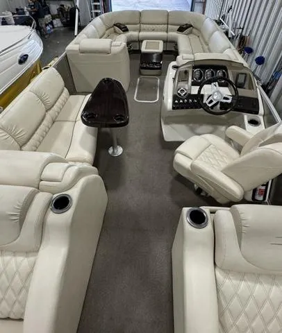 Slide: The Image of Luxurious 2013 Bennington 2575 R pontoon boat interior with plush seating and modern dashboard. - 24