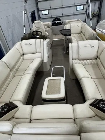 Slide: The Image of 2013 Bennington 2575 R pontoon boat with luxurious beige seating and modern interior design. - 28