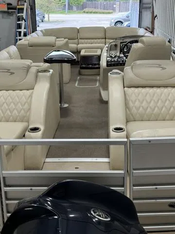 Slide: The Image of 2013 Bennington 2575 R pontoon boat with luxurious beige seating and modern dashboard. - 31