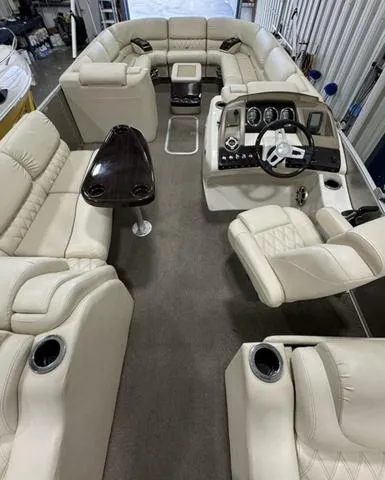 Slide: The Image of 2013 Bennington 2575 R pontoon boat interior with plush seating and modern dashboard. - 33